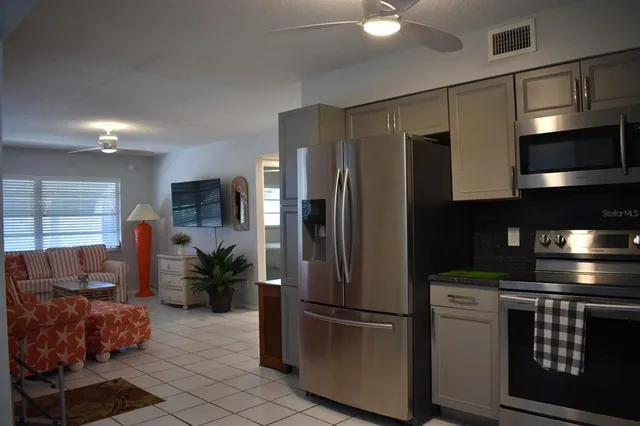 a kitchen with stainless steel appliances a refrigerator and a stove top oven