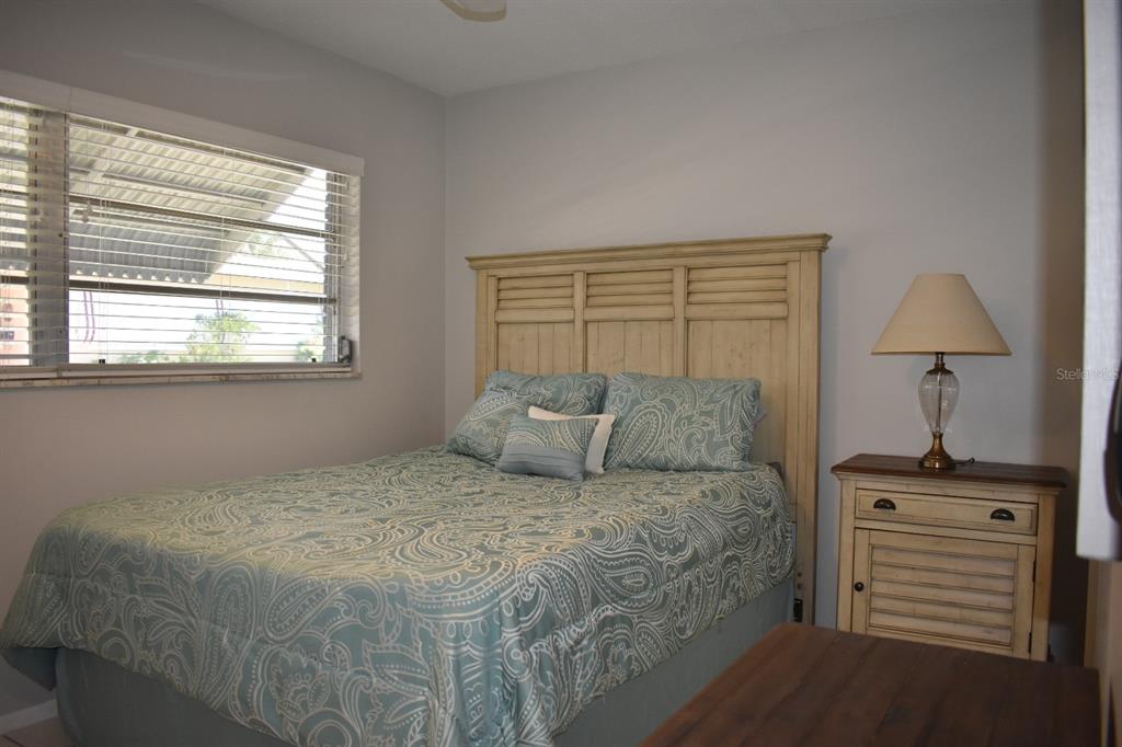 250 Rosery Road Northwest, Unit 264 Largo, FL 33770 - Photo 9 of 18 a large bed sitting in a bedroom next to a window