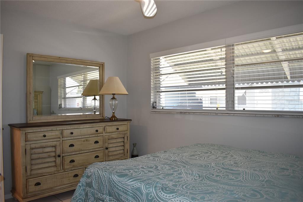 250 Rosery Road Northwest, Unit 264 Largo, FL 33770 - Photo 10 of 18 a bedroom with a large bed and a window