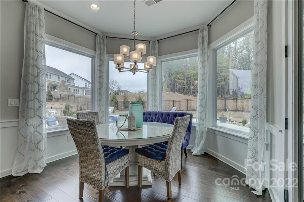 1912 Masons Bend Drive Fort Mill, SC 29708 - Photo 11 of 32 a dining room with furniture a chandelier and wooden floor