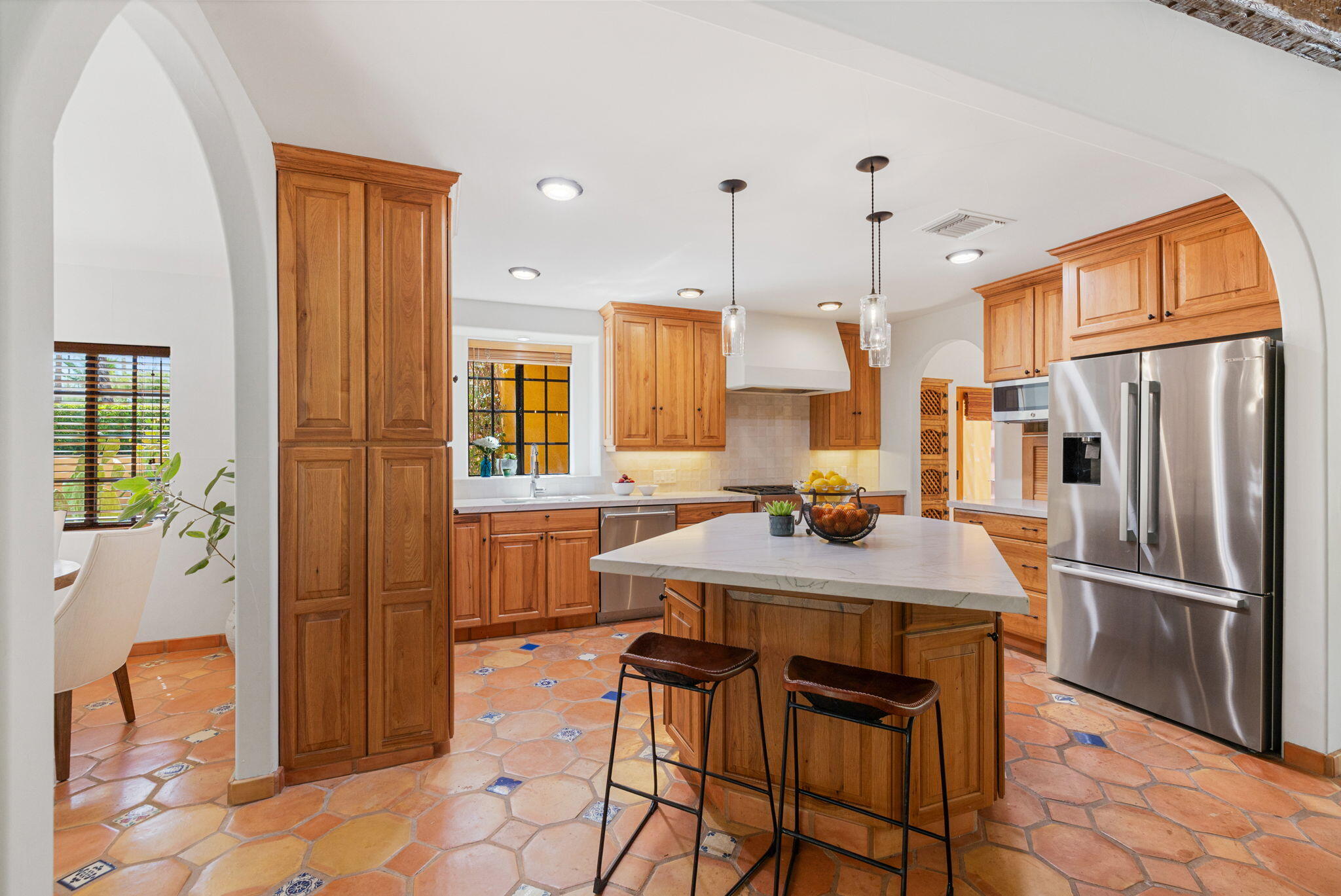 71429 Mirage Road Rancho Mirage, CA 92270 - Photo 49 of 65 a kitchen with stainless steel appliances granite countertop a refrigerator a sink a stove and a dining table with wooden floor