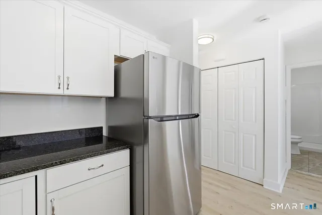 a kitchen with a refrigerator and cabinets