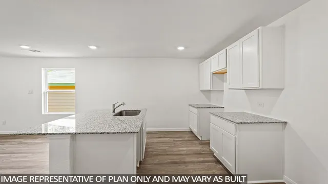 a kitchen with stainless steel appliances granite countertop a sink and a stove