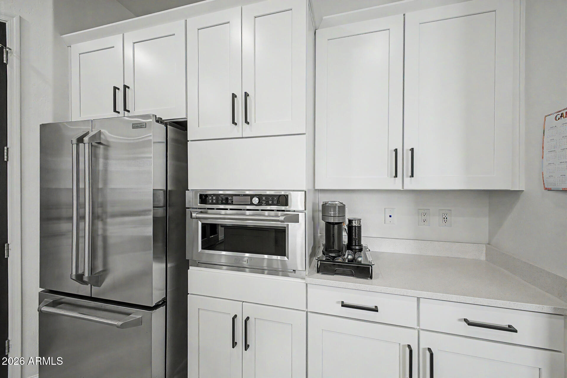 6511 West Steed Ridge Phoenix, AZ 85083 - Photo 12 of 41 a kitchen with white cabinets and stainless steel appliances