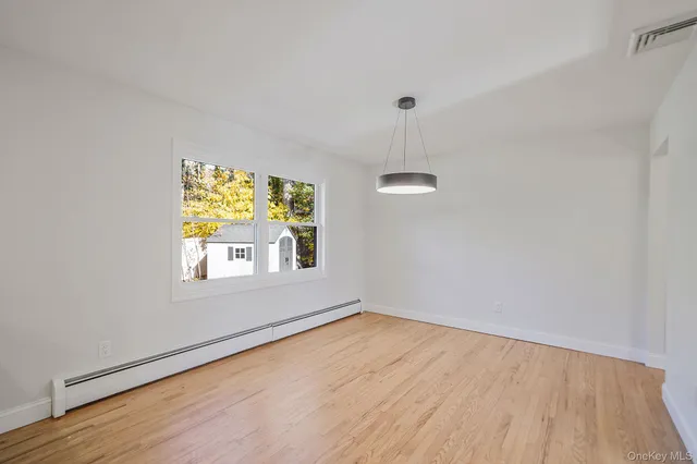a view of a kitchen with a sink dishwasher a refrigerator and wooden floor