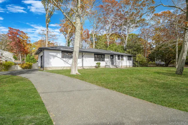 a front view of house with yard and green space