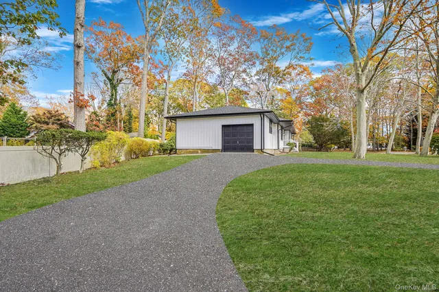 a front view of a house with a yard and trees