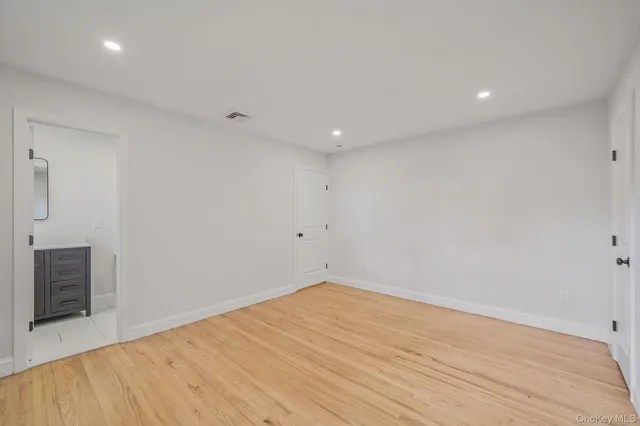 a bathroom with a toilet a sink a shower and a mirror