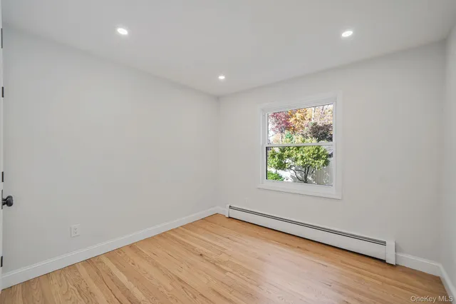 a view of room with wooden floor