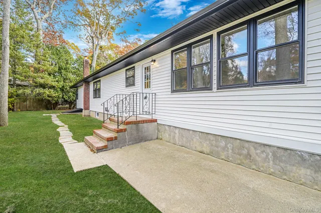 a view of a house with backyard and sitting area