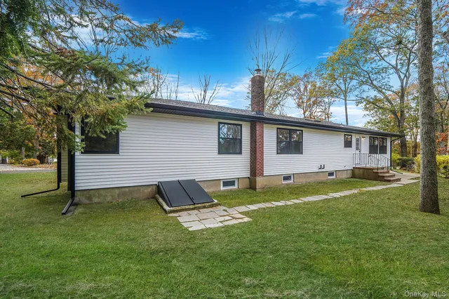 a backyard of a house with table and chairs