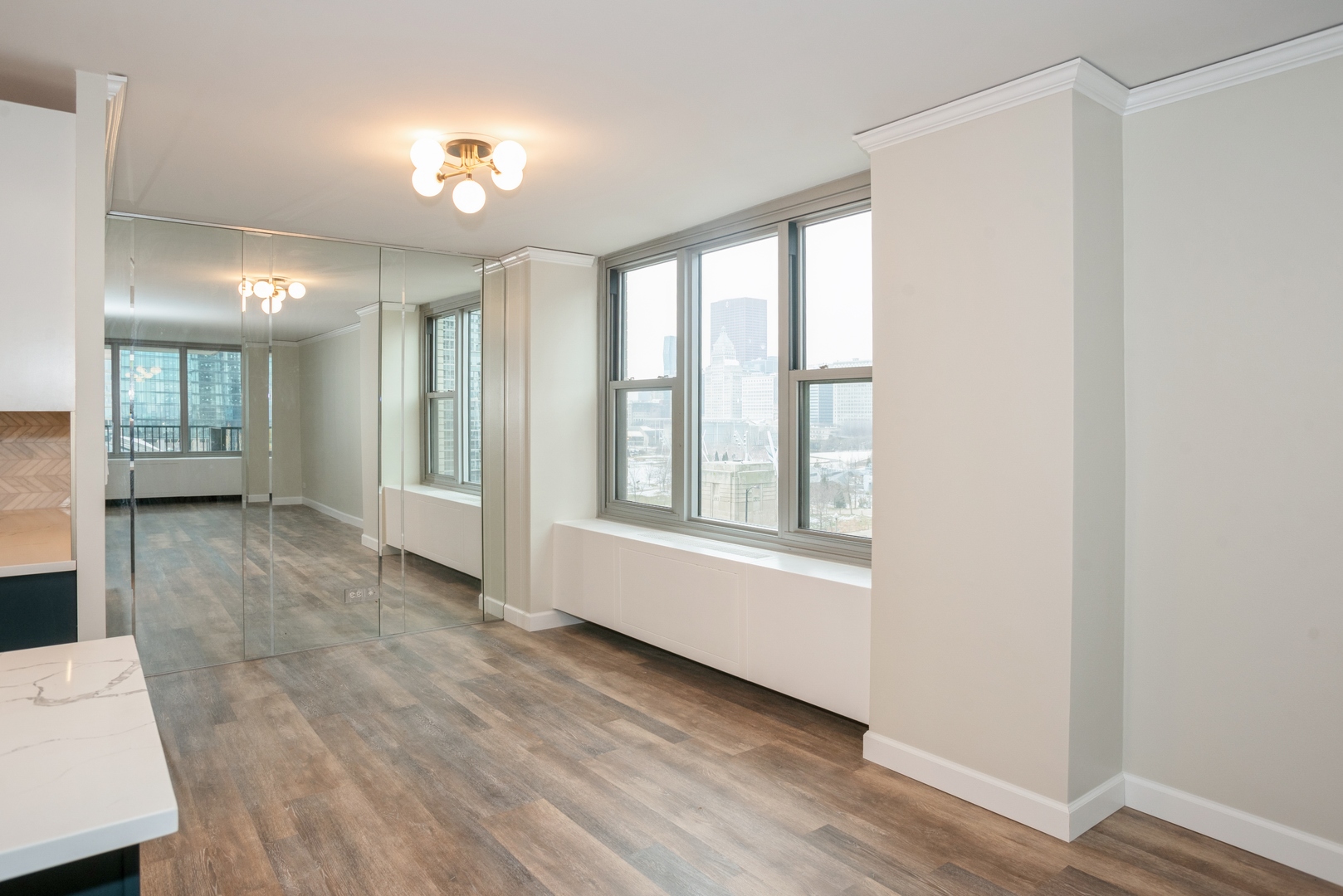 400 East Randolph Street, Unit 1020 Chicago, IL 60601 - Photo 2 of 27 a view of livingroom with hardwood floor and window