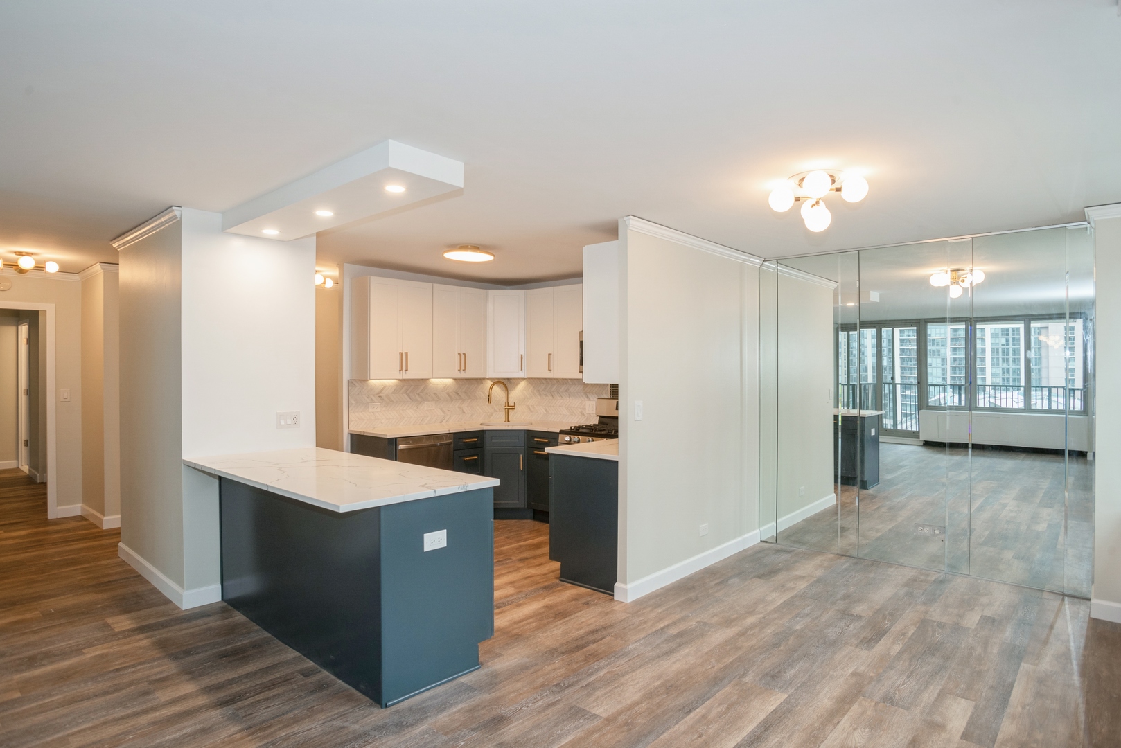 400 East Randolph Street, Unit 1020 Chicago, IL 60601 - Photo 3 of 27 a kitchen with a sink a refrigerator and a stove