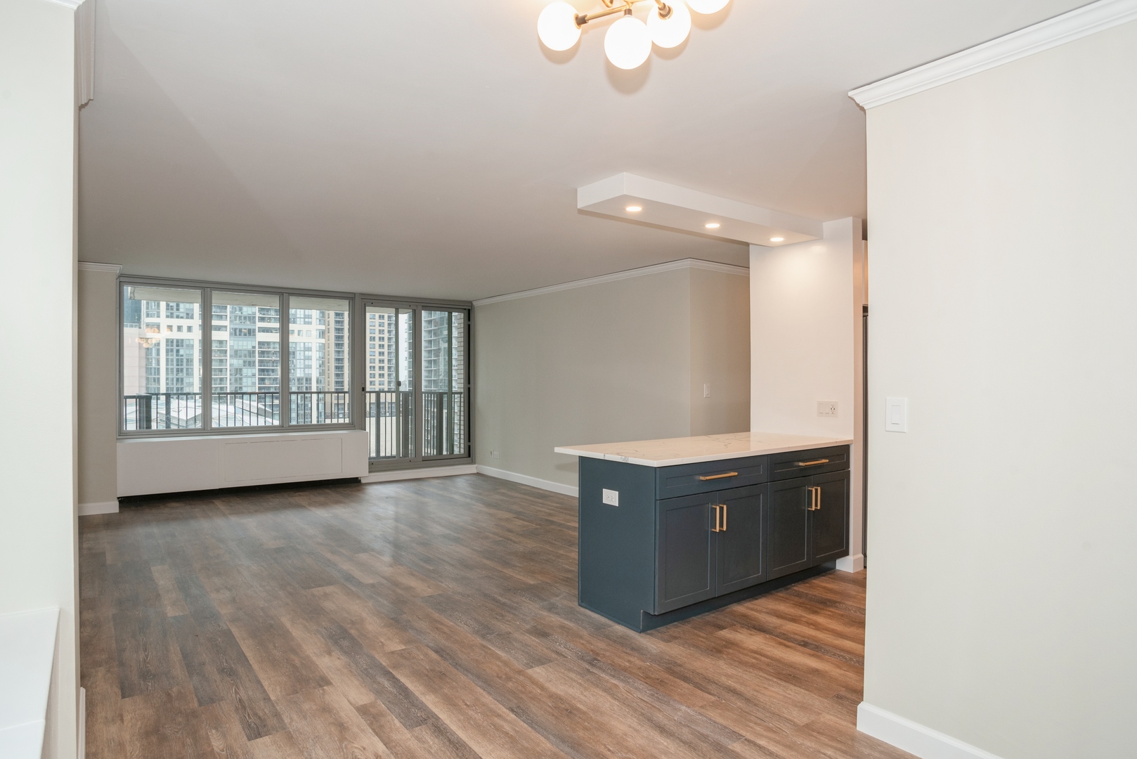 400 East Randolph Street, Unit 1020 Chicago, IL 60601 - Photo 6 of 27 an empty room with wooden floor and window