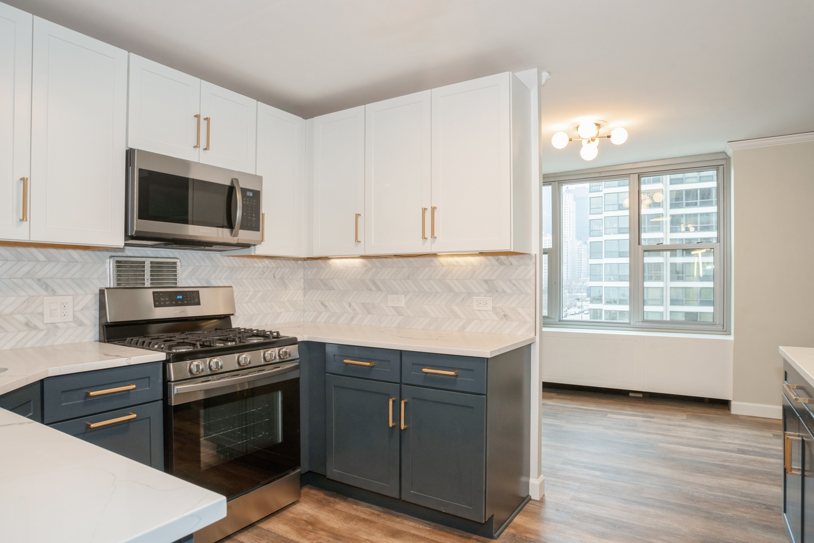 400 East Randolph Street, Unit 1020 Chicago, IL 60601 - Photo 7 of 27 a kitchen with granite countertop a stove and a sink