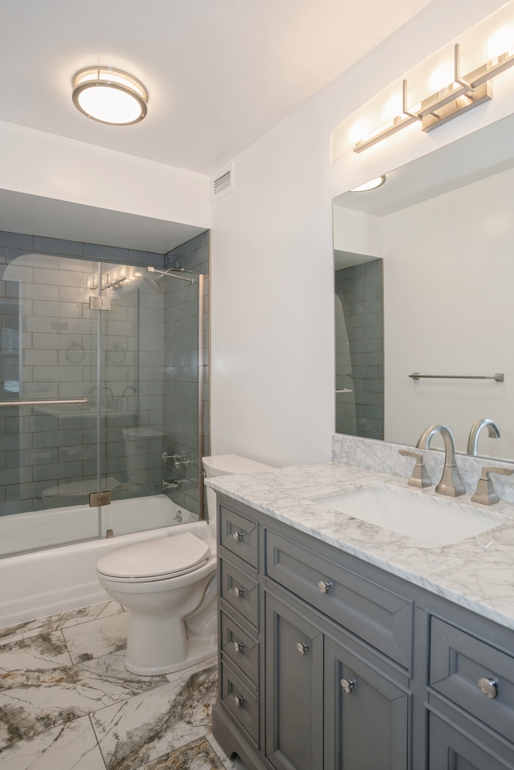400 East Randolph Street, Unit 1020 Chicago, IL 60601 - Photo 8 of 27 a bathroom with a sink toilet and shower