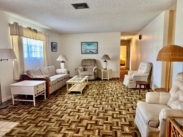 a living room with furniture and a rug