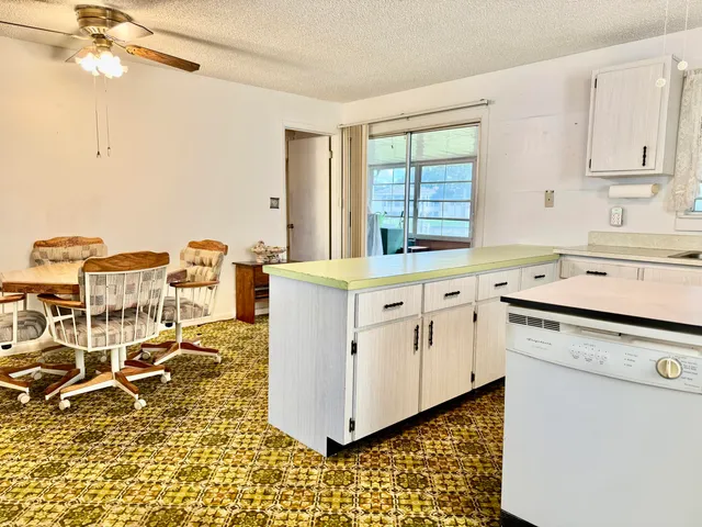 a kitchen with cabinets and wooden floor