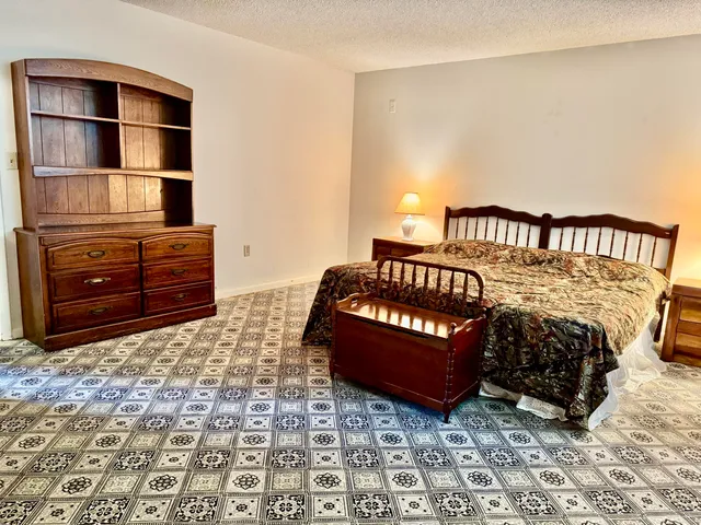 a bedroom with a bed and cabinets