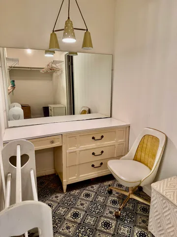 a bathroom with a sink mirror and a toilet