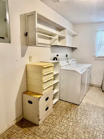 a utility room with cabinets and washer