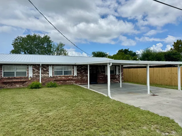a view of a yard with a table and chairs
