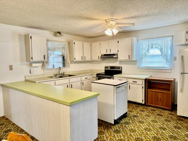 a kitchen with a sink stove and cabinets