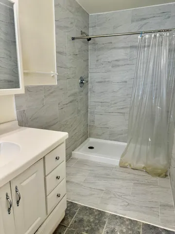 a bathroom with a bathtub and shower