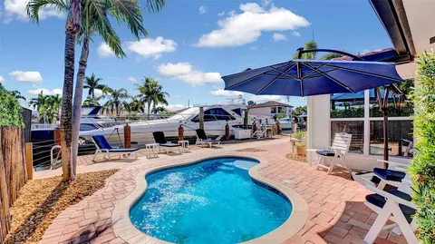 a view of a swimming pool with chairs