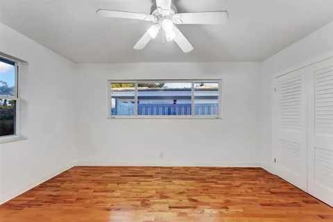 a view of a hallway with wooden floor and entryway