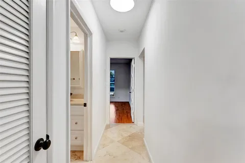 a large kitchen with white cabinets and stainless steel appliances