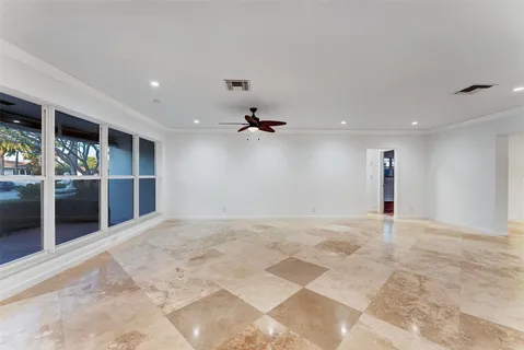 a kitchen with granite countertop a stove a sink a refrigerator and a wooden floor