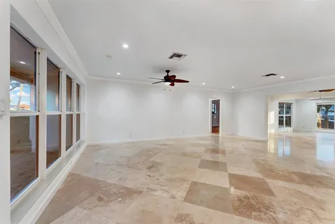 a view of an empty room with window and cabinet