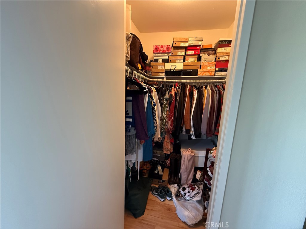 9565 Graham Street Cypress, CA 90630 - Photo 11 of 29 a view of walk in closet with clothes and shoes