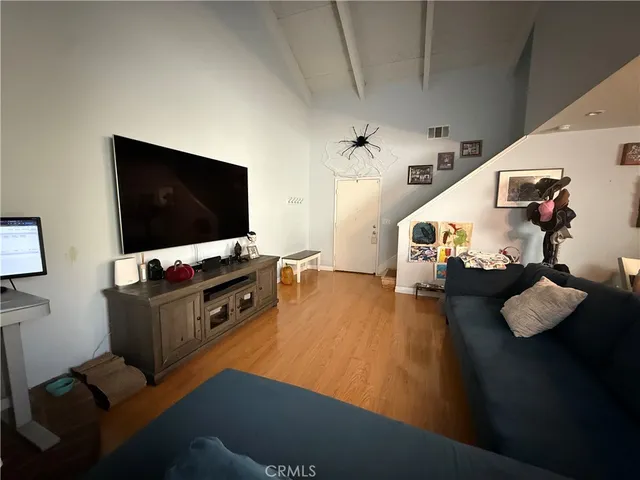 a view of staircase with lots of frames on wall and stairs