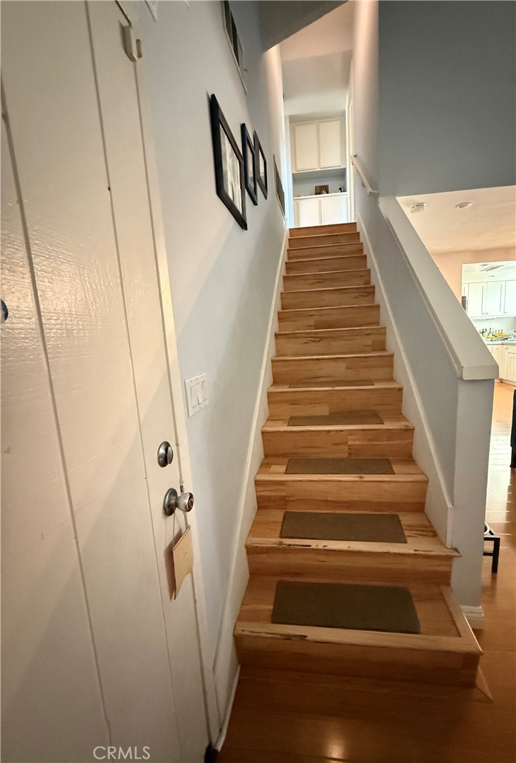 9565 Graham Street Cypress, CA 90630 - Photo 14 of 29 a view of staircase with lots of frames on wall and stairs