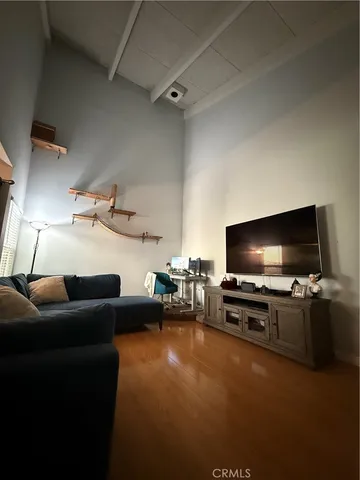 a view of a workspace with furniture and wooden floor