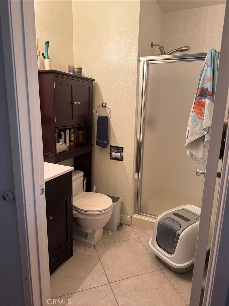 9565 Graham Street Cypress, CA 90630 - Photo 18 of 29 a bathroom with a toilet and a shower