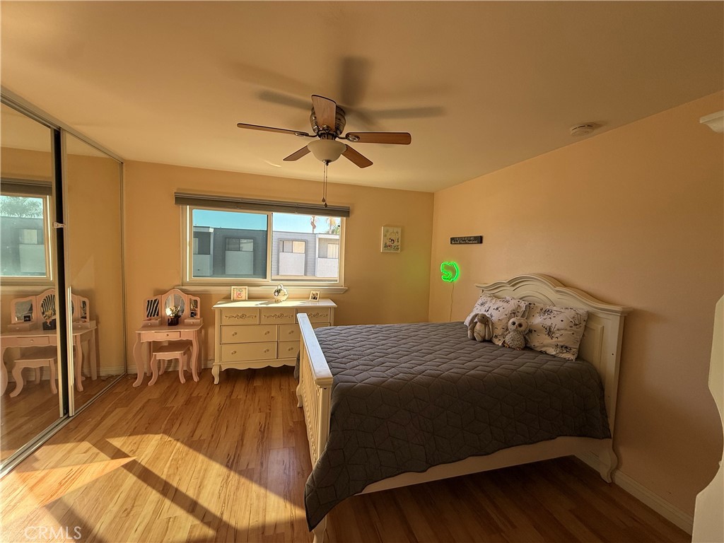 9565 Graham Street Cypress, CA 90630 - Photo 3 of 29 a bedroom with a bed and wooden floor