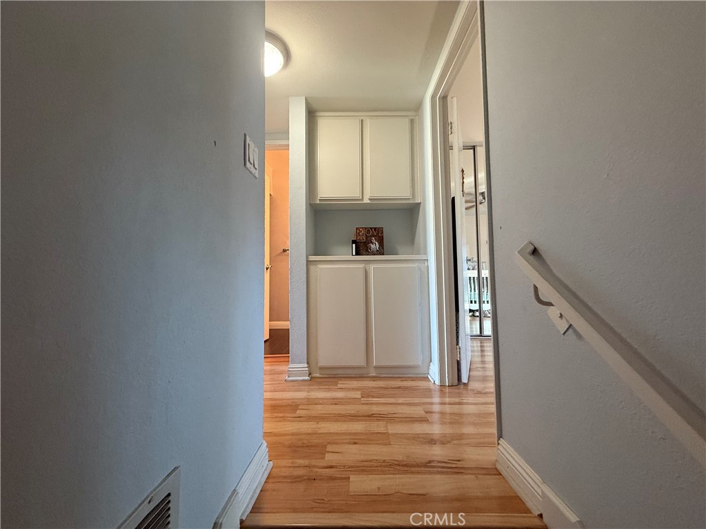9565 Graham Street Cypress, CA 90630 - Photo 5 of 29 a view of a hallway with wooden floor and staircase