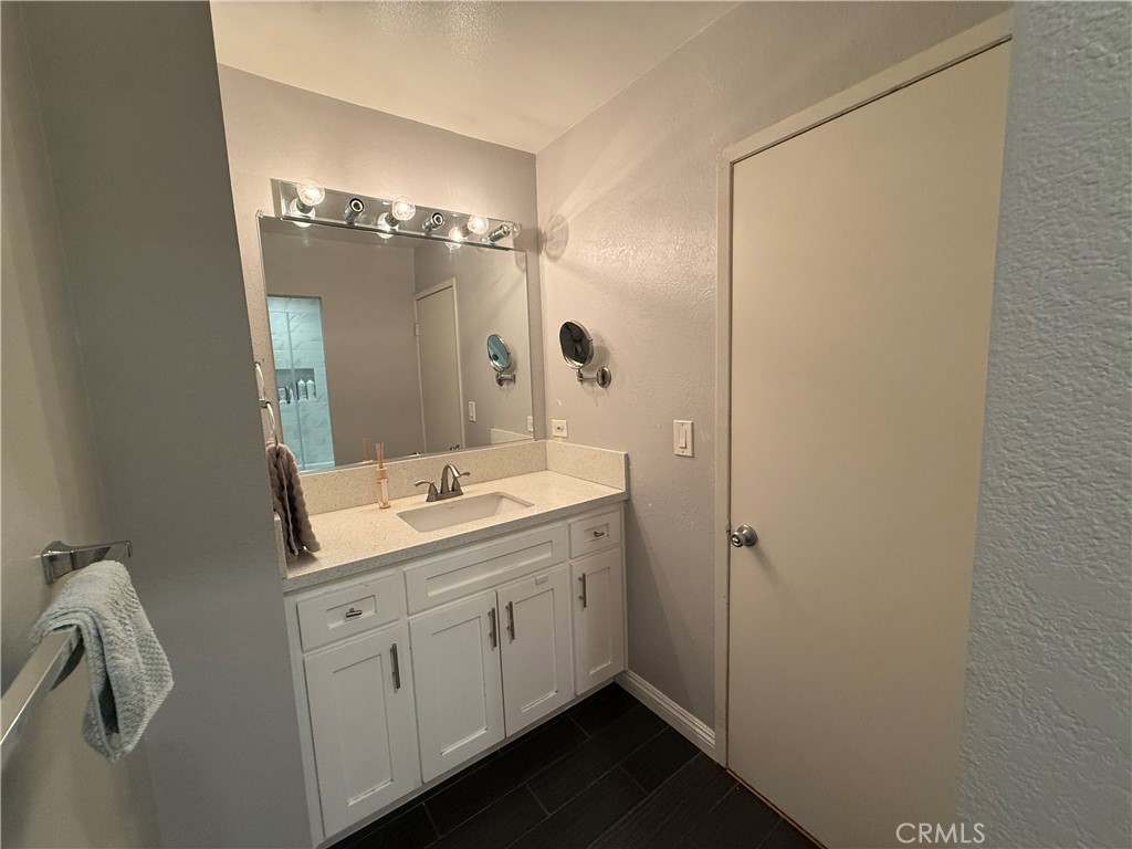 9565 Graham Street Cypress, CA 90630 - Photo 7 of 29 a bathroom with a double vanity sink and mirror