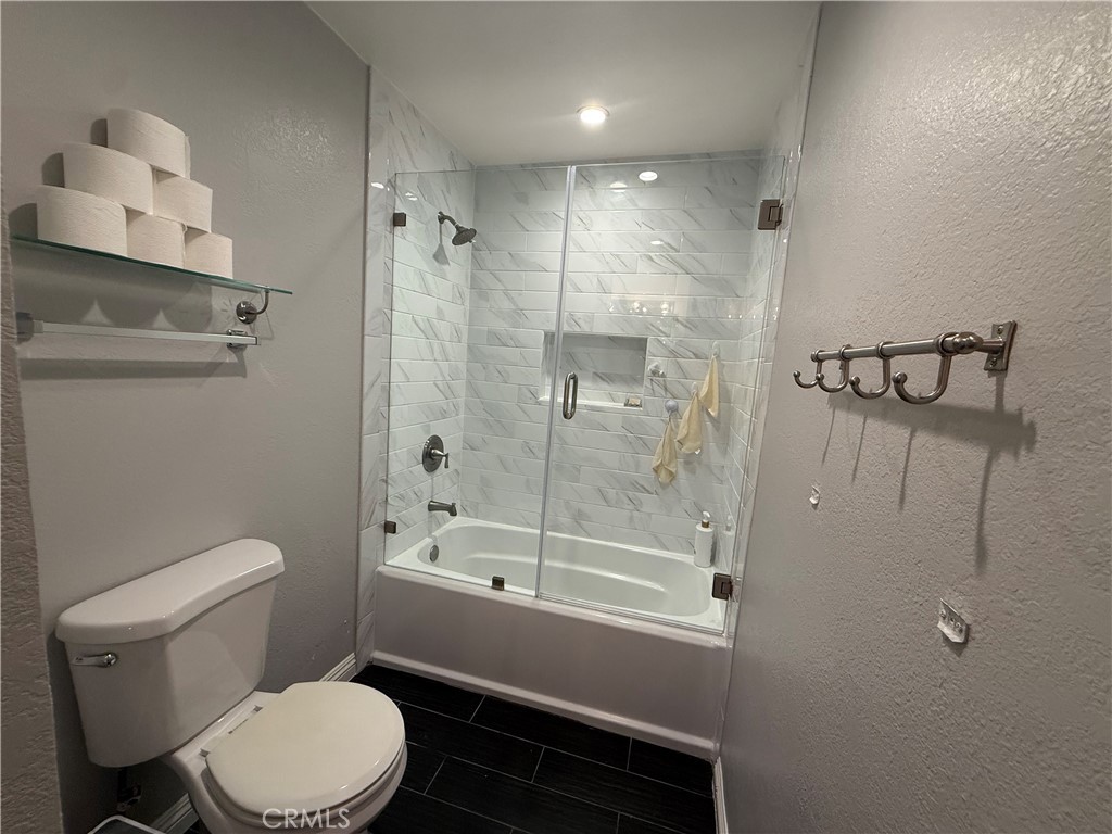9565 Graham Street Cypress, CA 90630 - Photo 8 of 29 a bathroom with a toilet and shower