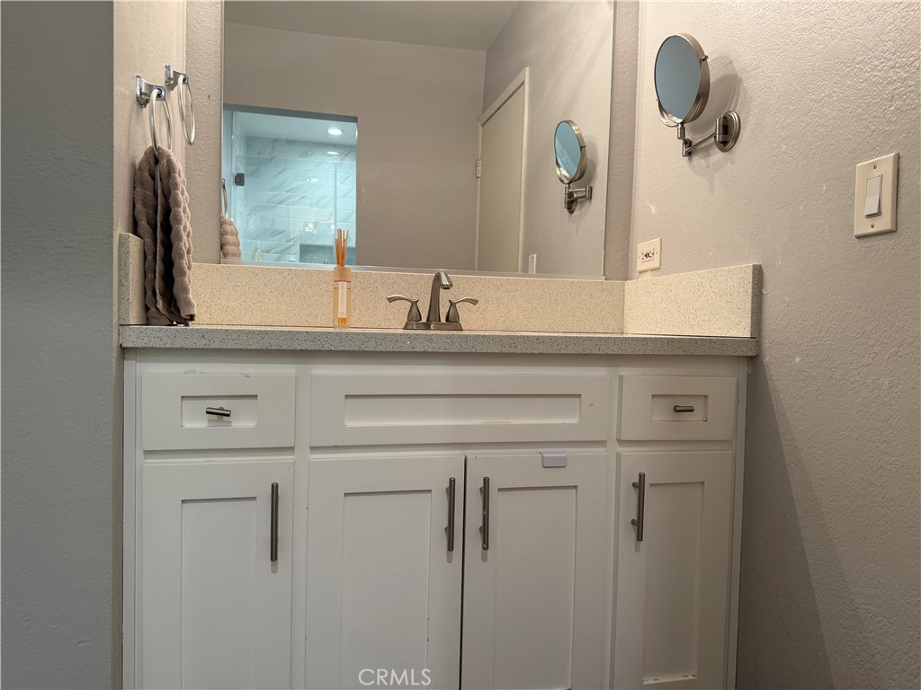 9565 Graham Street Cypress, CA 90630 - Photo 9 of 29 a bathroom with a sink vanity and mirror