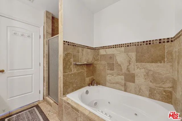 a bathroom with a bathtub and a shower
