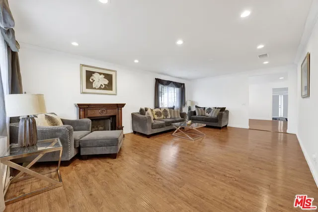 a living room with furniture or fireplace and a wooden floor