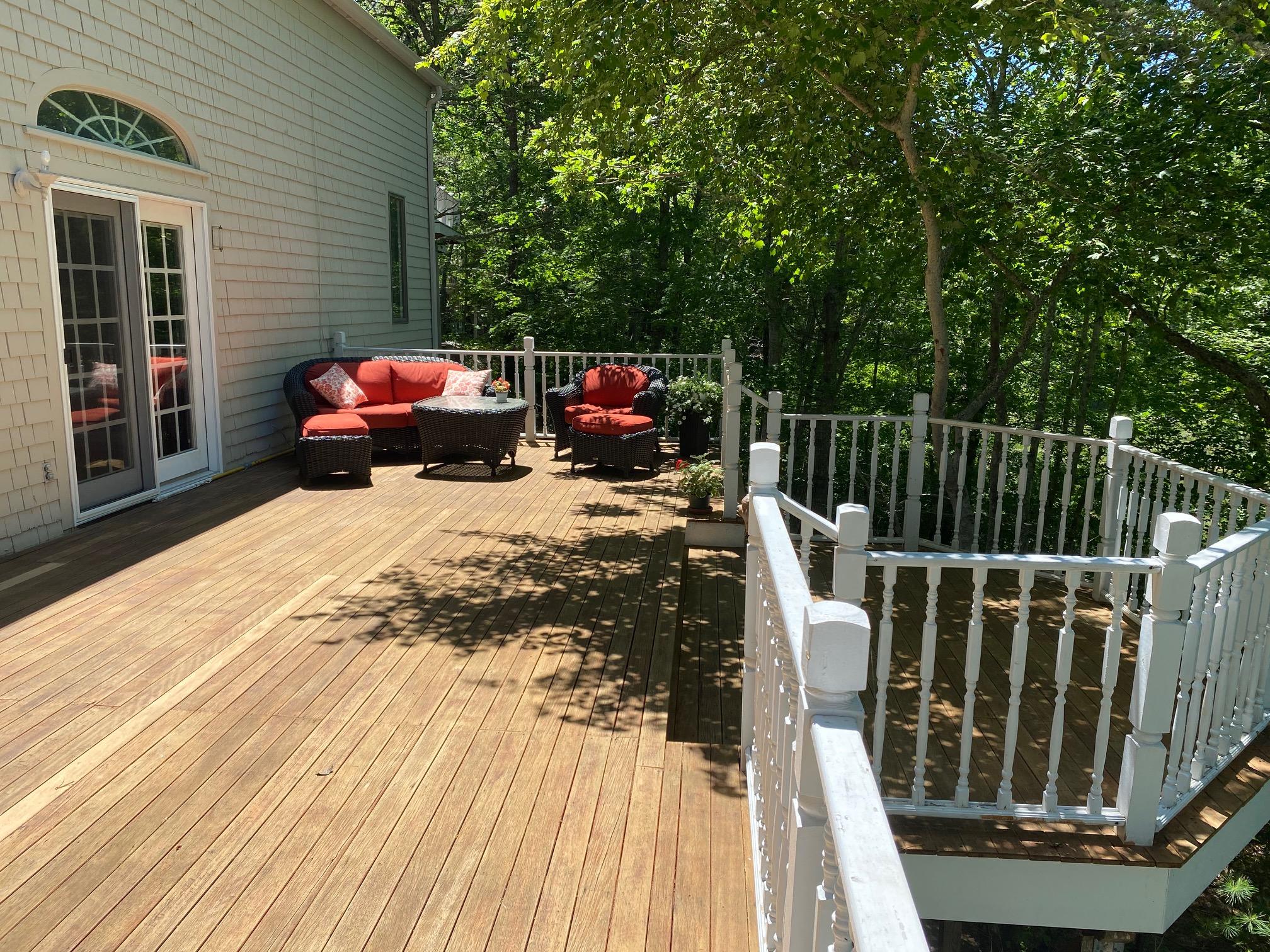 56 Summersea Road Mashpee, MA 02649 - Photo 29 of 44 a view of a roof deck with table and chairs a barbeque with wooden floor and fence