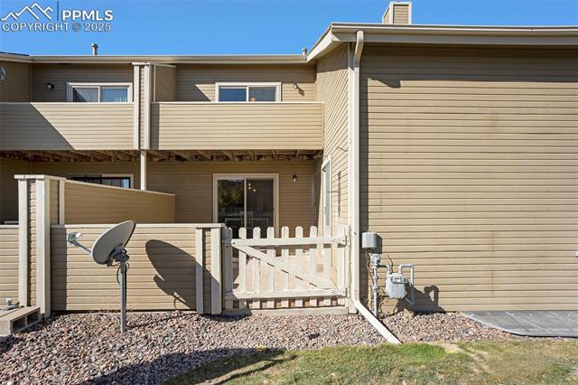 86 Rising Sun Terrace Colorado Springs, CO 80921 - Photo 29 of 36 Back of property with a gate and a chimney