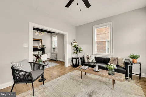 a living room with furniture and wooden floor