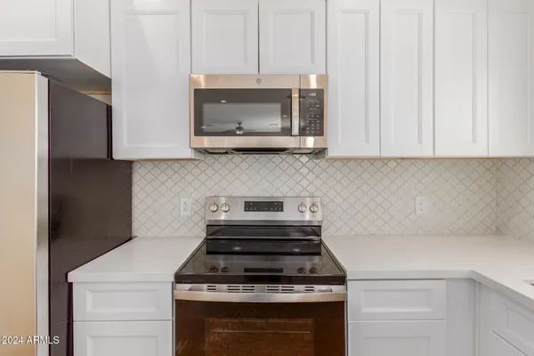 a kitchen with a stove and a microwave