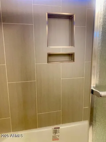 a view of empty room with window and wooden floor